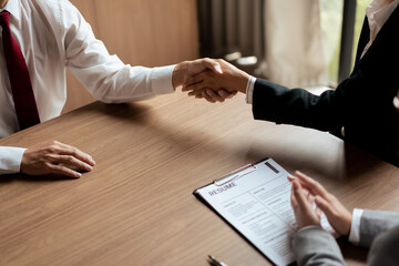 HR manager woman shaking hand and congratulation with male candidate after successful interviewing - obrazy, fototapety, plakaty