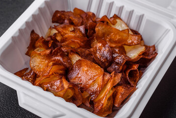 Delicious crispy potato chips with salt and spices