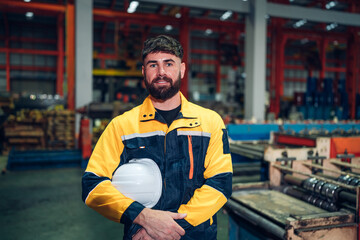 Fototapeta premium Portrait of Smiling Professional Industry Engineer standing and looking camera, Worker Wearing Safety Uniform and Hard Hat at factory. Machine maintenance technician operation concept.