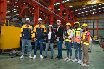 Chief Engineer and Project Manager Wearing Safety Vests and Hard Hats, Talking and planning optimization of production.