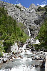 Fototapeta na wymiar Waterfall and Mountain Stream in the Swiss Alps in Valais, Switzerland