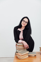 woman with a stack of books in the library training science education