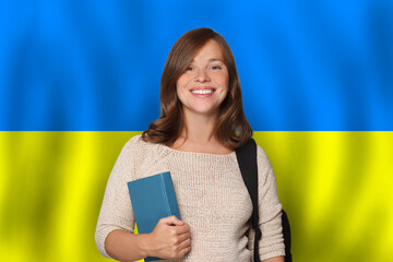 Happy woman student against Ukrainian flag background. Travel, education and learn language in Ukraine concept