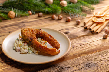 Traditional Christmas dinner in Czech Republic - fried carp with potato salad