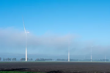 Foto auf Leinwand Windmolens tussen de wolken   Windmills among the clouds, Flevoland province, The Netherlands © Holland-PhotostockNL