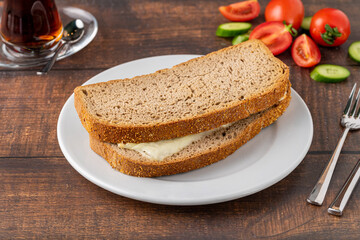 Cheddar toast on white porcelain plate on wooden table