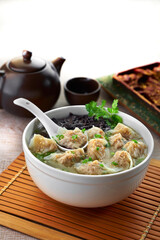 traditional chinese Hong Kong dim sum steamed fresh hot siew mai meat dumpling soup in bamboo basket on grey wood table background breakfast halal food menu for restaurant asian cafe