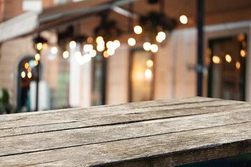 blurred background of bar and dark brown retro wooden table for product