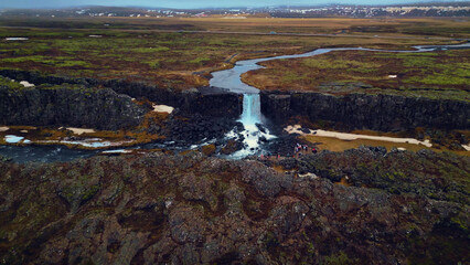 Aerial view of oxarafoss waterfall in iceland, spectacular huge water cascade falling down off...