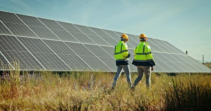 Men, walk and teamwork for solar installation on field or tablet, green energy or sun electricity. Male person, discussion of future resource for environment impact, saving innovation or sustainable