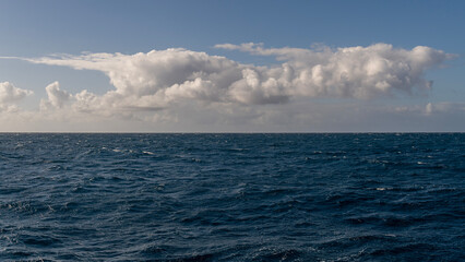 Panorama of beautiful white clouds above the Pacific Ocean in Kauai, Hawaii, United States.
