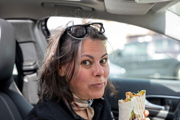 Elegant Woman Eating a Kebab in a Car in Switzerland.