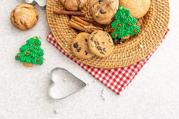 Festive Christmas cookies in a wicker plate on the kitchen table.