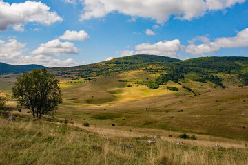 Obraz premium Sinkholes in the karst landscape near Gornje Ratkovo in the Ribnik municipality of Banja Luka region, Republika Srpska, Bosnia and Herzegovina. Early September