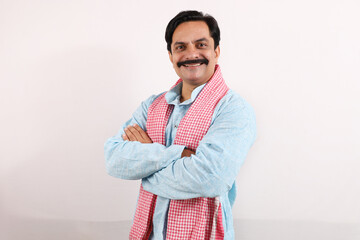 Happy rural Indian farmer standing in the white background, the passionate farmer full of enthusiasm shows sense of achievement and accomplishments.