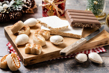 Fototapeta na wymiar Traditional Christmas sweet, nougat and Christmas sweet almonds on wooden table