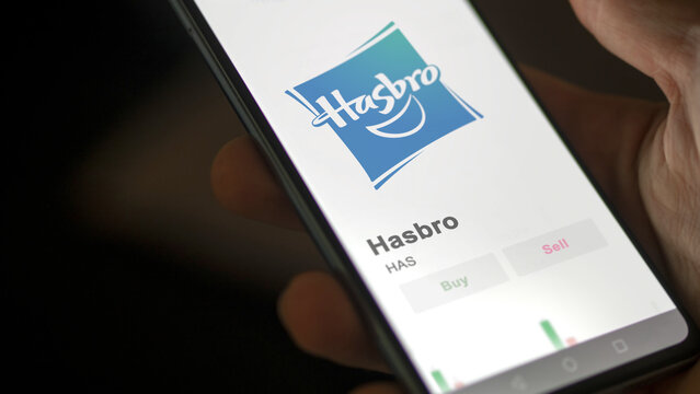 Logo of Hasbro on the screen of an exchange. Hasbro price stocks, $HAS on a device.