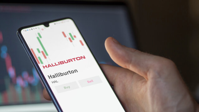 Logo of Halliburton on the screen of an exchange. Halliburton price stocks, $HAL on a device.