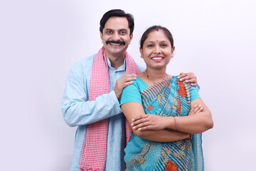 Indian rural happy villager couple standing together on a white background.
