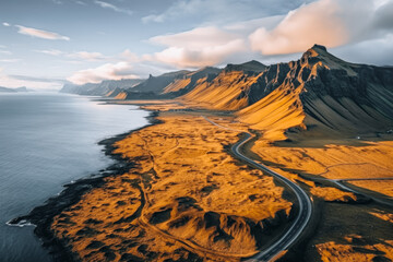 Fototapeta premium Scenic road in Iceland, beautiful nature landscape aerial panorama, mountains and coast at sunset, nordic
