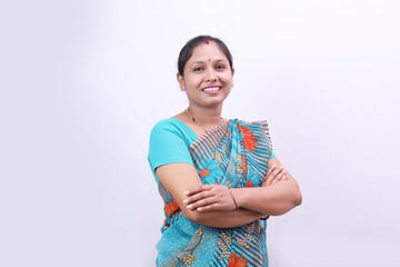 Indian rural happy villager woman standing in saree on a white background. Feeling proud and having...