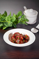 traditional chinese stir fried fat pork ribs roll spicy and sweet sauce meat main course in plate on grey vintage background cafe hotel luxury halal food restaurant banquet menu