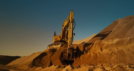 Construction Site On A Hot Sunny Day: Industrial Excavator Digging Sand To Lay Foundation for Building New Apartment Block. Workers Operating Heavy Machinery To Complete A Real Estate Project.