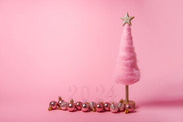 Isolated bright pink background fluffy creative Christmas tree made of wool, transparent numbers 2024 with shiny balls. New Year holiday card. Template for text. Cotton candy, online sales, shopping