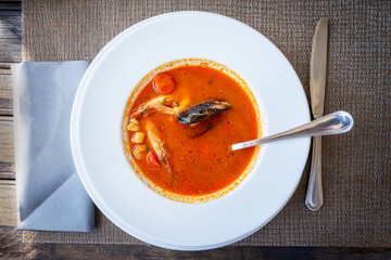 Tomato seafood soup with mussels and mixed seafood served in a traditional seafood restaurant in Orebich, Croatia.