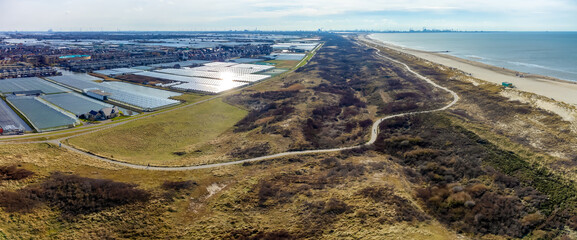 Panorama view of the dunes, beach, and the Westland greenhouses seen from above from the little...
