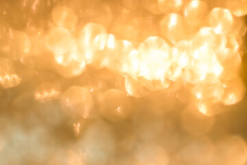 Gold glitter blur abstract background of bright sparkling white light glittering bokeh chandelier...