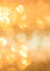 Gold glitter blur abstract background of bright sparkling white light glittering bokeh chandelier...