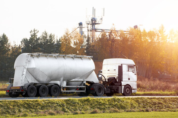Oil cargo truck driving on the road hauling petrol products. Fuel delivery transportation, delivery...