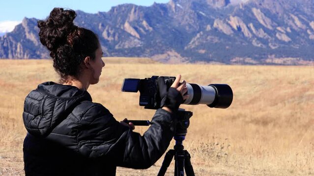 Professional Wildlife Photographer Using Camera on Tripod, Outdoor Photography