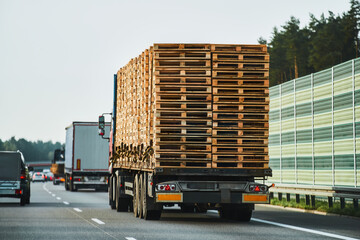 A Truck transporting a European pallet load on the highway. Truck Carrying European Pallet Load on the Road.