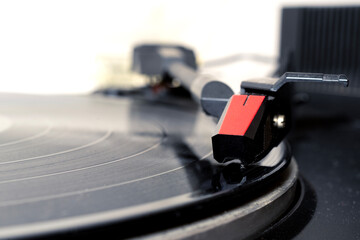 Detail of a vintage turntable playing a vinyl, shallow depth of field