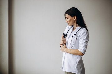 Young woman doctor in lab coat with stethoscope