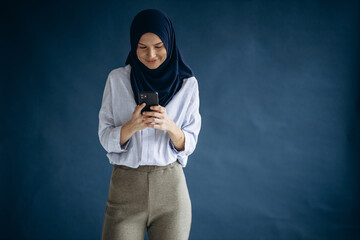 Muslim woman using mobile phone