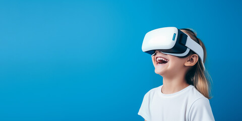 Young girl getting experience using VR headset glasses isolated on a blue background with copy space
