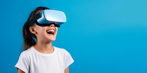 Young girl getting experience using VR headset glasses isolated on a blue background with copy space