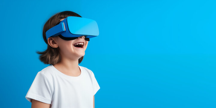 Young girl getting experience using VR headset glasses isolated on a blue background with copy space