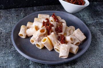Pasta with ricotta and dried tomatoes. Healthy and tasty vegetarian Italian food.