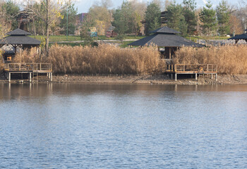 beauty plays for relax. lake and wooden gazebo , decorative wooden foot path.