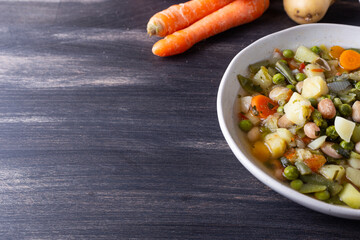Vegetable and legume minestrone served with croutons. Complete vegan dish ideal for lunch and dinner. Italian minestrone.