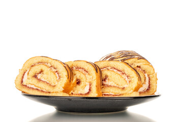 One delicious cherry roll cut into slices on a ceramic dish, macro, isolated on white background.