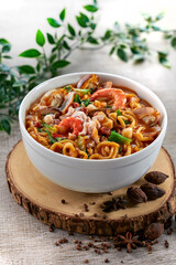 traditional chinese healthy braised puritan noodle with clam prawn seafood spicy tom yum thick soup in bowl on grey vintage background cafe hotel luxury halal food restaurant banquet menu