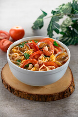 traditional chinese healthy braised puritan noodle with clam prawn seafood spicy tom yum thick soup in bowl on grey vintage background cafe hotel luxury halal food restaurant banquet menu