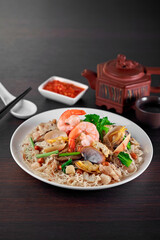 traditional chinese wok stir fried bee hoon noodle mee goreng with clam prawn seafood in plate on grey vintage background cafe hotel luxury halal food restaurant banquet menu