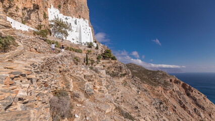 Fototapeta premium The Hozoviotissa Monastery standing on a rock over the Aegean sea in Amorgos island timelapse hyperlapse, Greece.