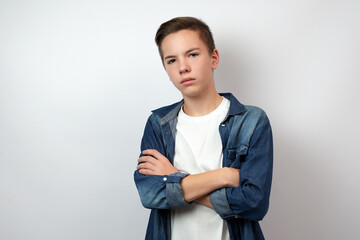 Portrait of teenage boy with crossed arms, standing looking camera